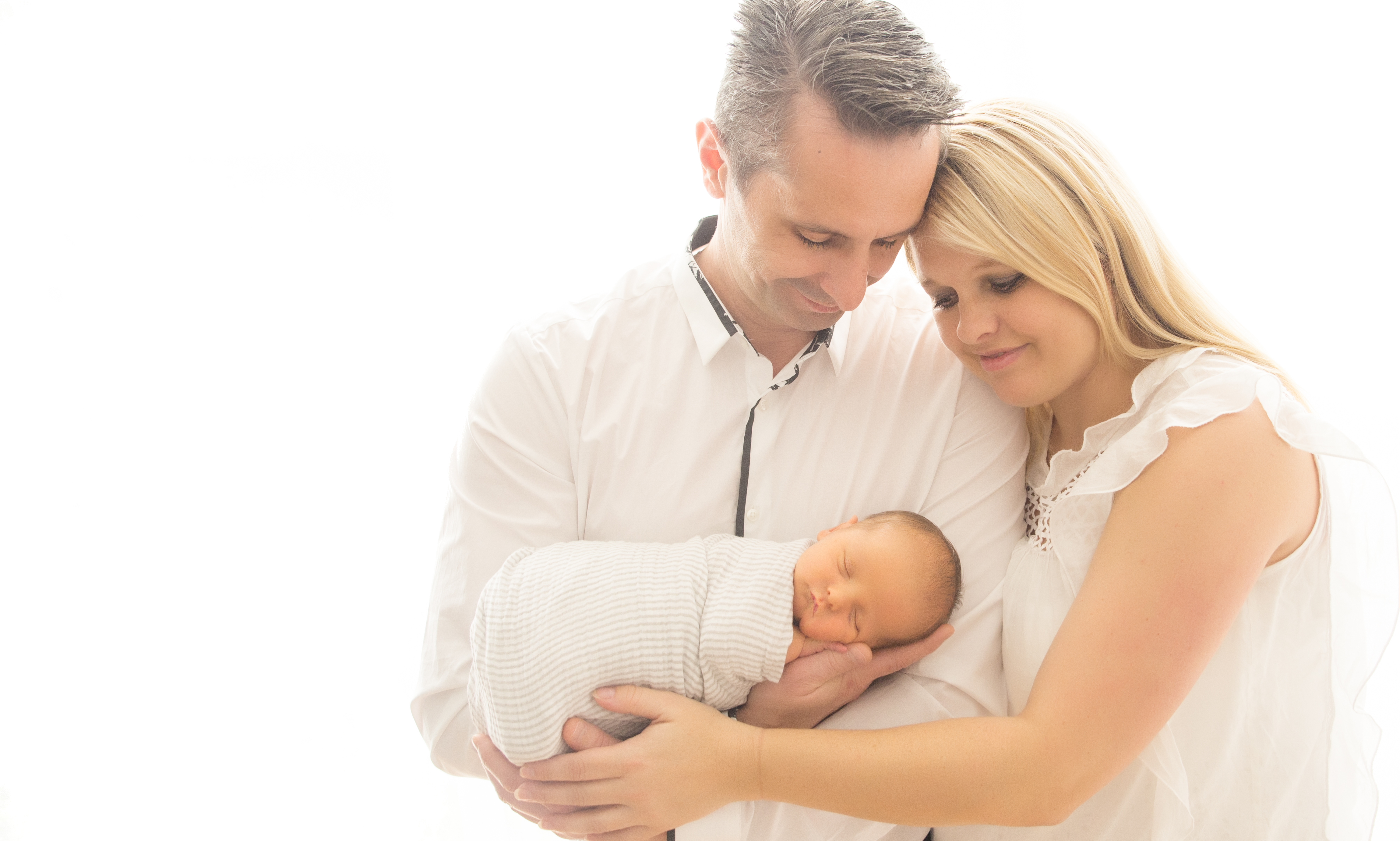 Mum and dad with newborn baby for family photography 