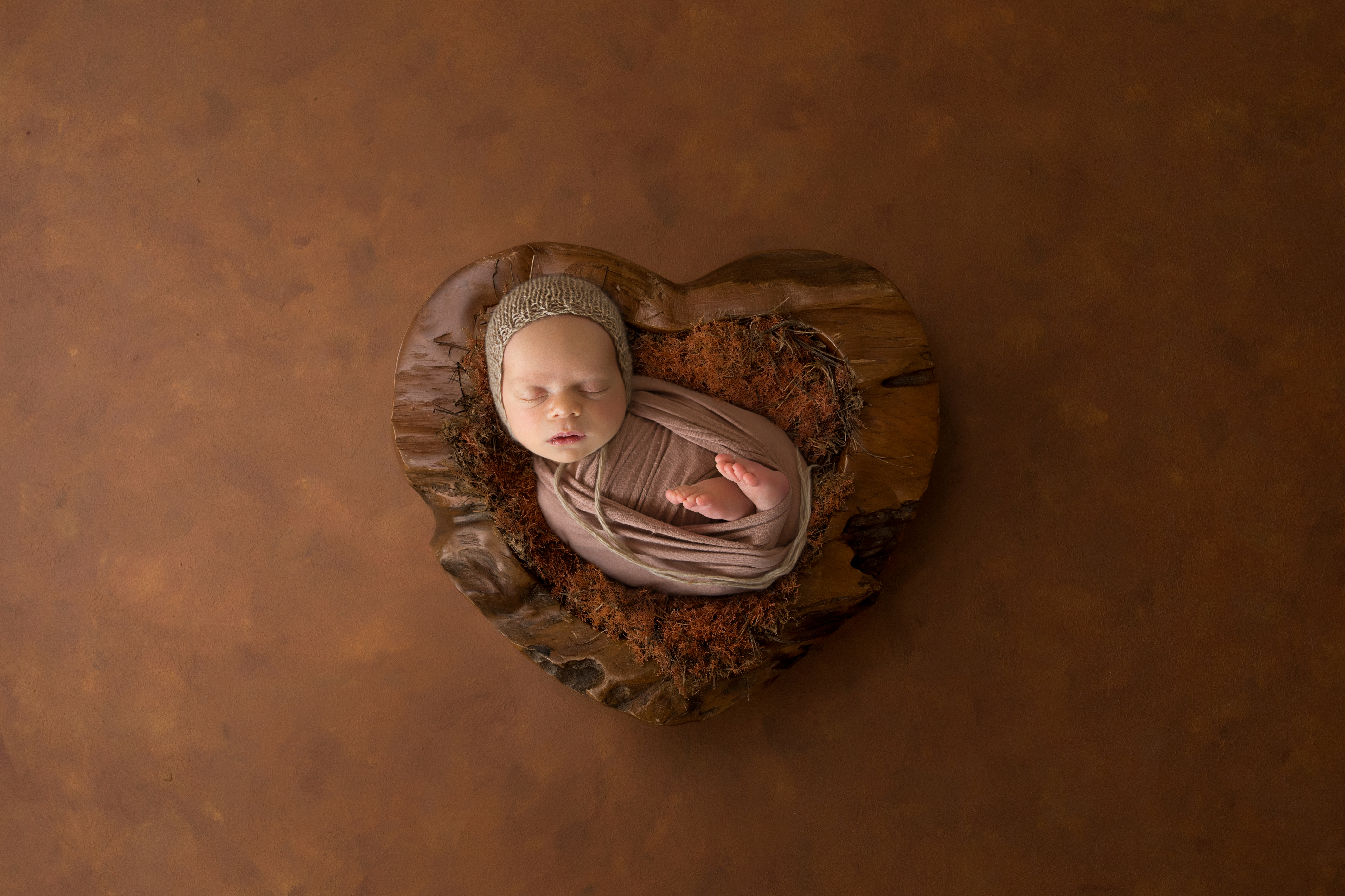 newborn baby placed in heart bowl 