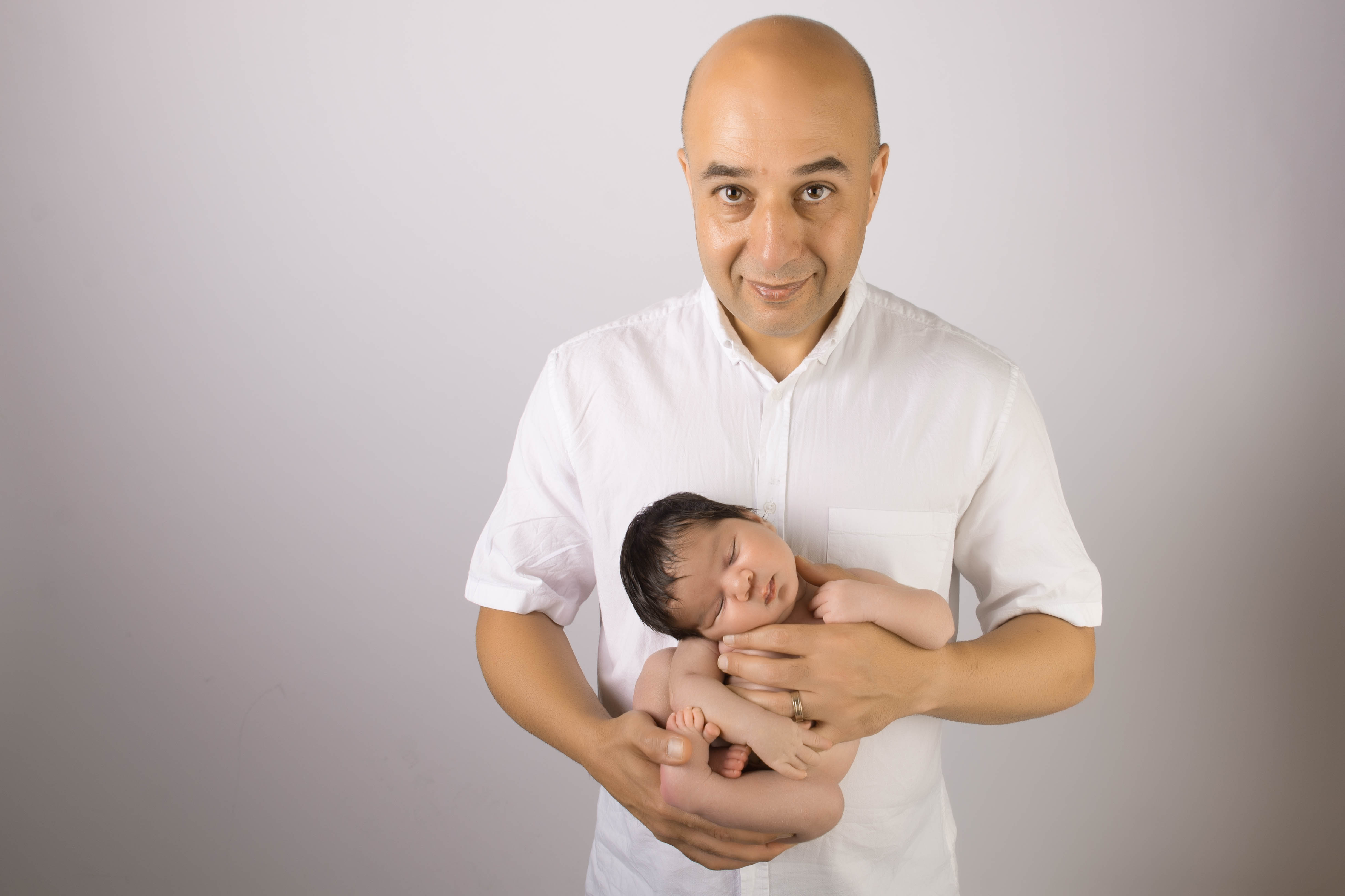 Dad holding newborn baby