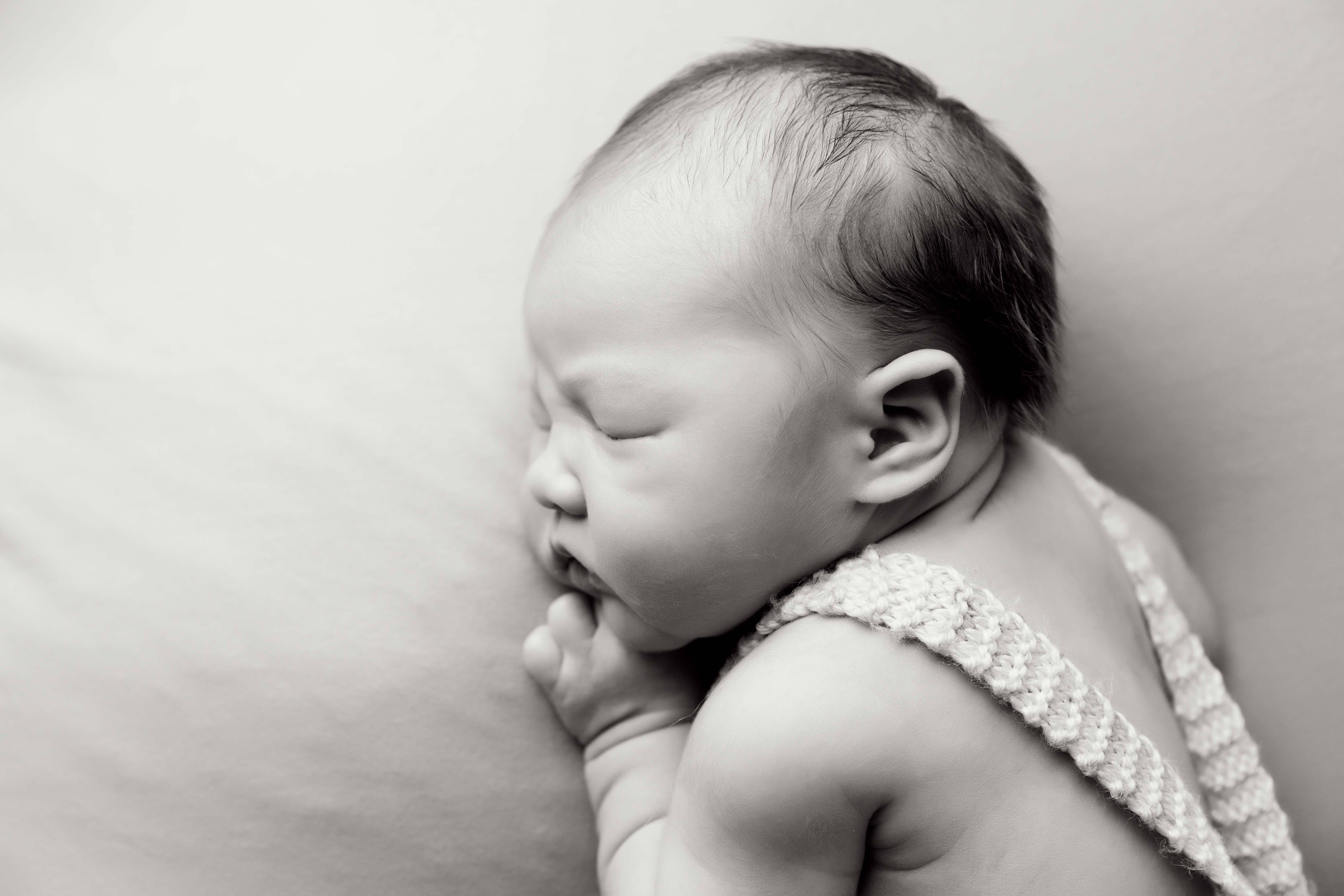 Side profile image of newborn baby.