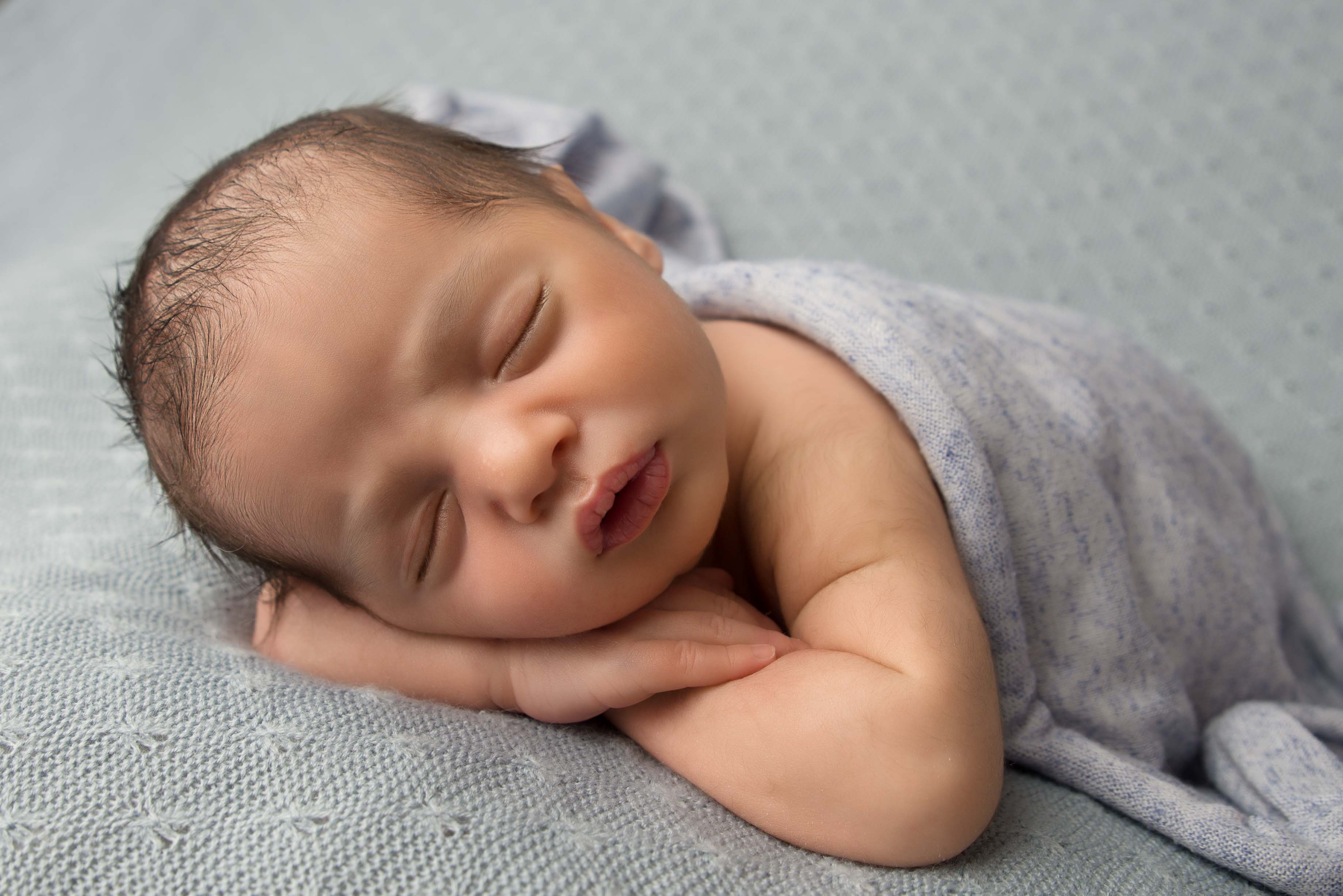 Newborn baby boy on blue blanket