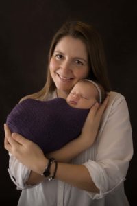 Mum and newborn baby pose