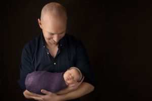 Dad holding newborn for newborn photo