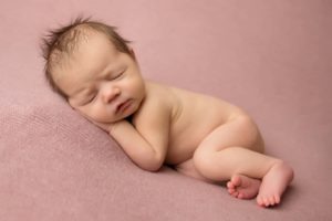 Cute newborn baby photo in pink blanket 