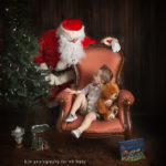 little boy looking up at santa in photoshoot