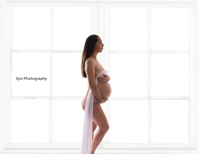 Maternity photo in front of stunning window