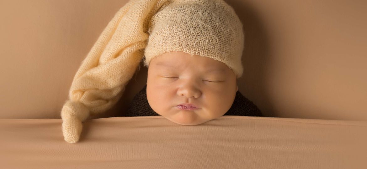 Baby with sleepy hat on.