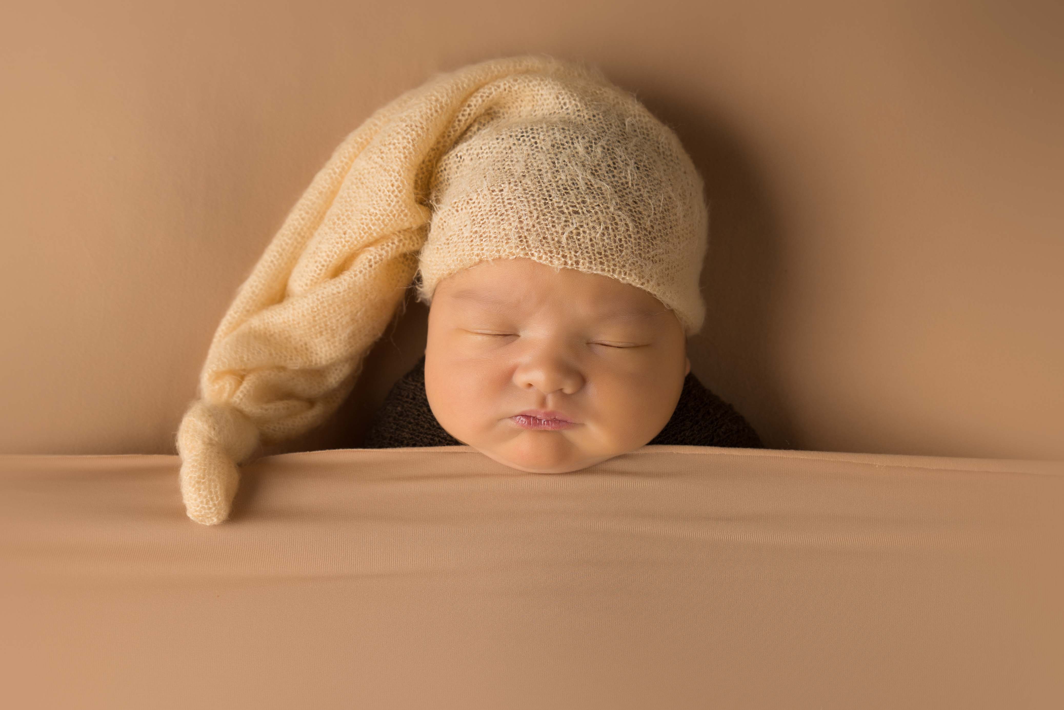 Baby with sleepy hat on.